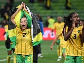 Jamaica's midfielder #02 Solai Washington (L) and Jamaica's defender #03 Vyan Sampson celebrate after their team qualified for the last 16 following the Australia and New Zealand 2023 Women's World Cup Group F football match between Jamaica and Brazil at Melbourne Rectangular Stadium, also known as AAMI Park, in Melbourne on August 2, 2023. (Photo by WILLIAM WEST/AFP via Getty Images)
