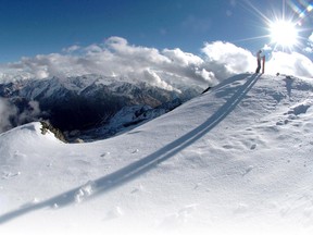 A Dutch snowboarder enjoys a panorama of the Austrian Alps in October 2004.