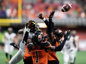 Hamilton Tiger-Cats and B.C. Lions battle in the air for the ball