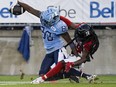 Argonauts wide receiver DaVaris Daniels (left) reaches into the end zone for a touchdown as Redblacks defensive back Abdul Kanneh defends in Toronto last night.