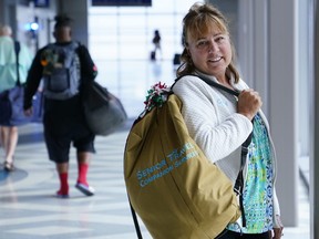 Carol Giuliani, who is a member of the Dementia-Friendly Airports Working group and works as a travel companion for seniors with dementia, stands for a portrait in Terminal 3 at Phoenix Sky Harbor International Airport after bringing a client from Minnesota Wednesday, Aug. 23, 2023, in Phoenix.