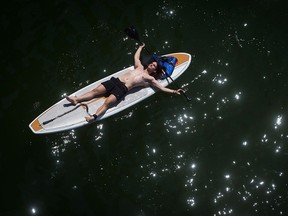 Doing it right: File photo of a paddleboarder with a life jacket on board and wearing a tether.