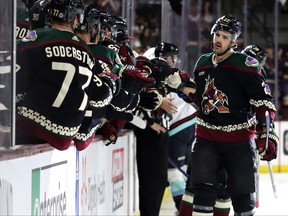 Jack McBain of the Arizona Coyotes celebrates a goal with the bench during action against the Seattle Kraken in the first period at Mullett Arena on April 10, 2023 in Tempe, Arizona.