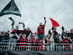 Vancouver FC fans celebrate in the stands.