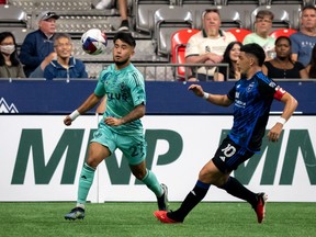 Vancouver Whitecaps' Ryan Raposo (27) tries to gain possession of the ball with pressure from San Jose Earthquakes' Cristian Espinoza (10) during first half MLS soccer action in Vancouver on Sunday, August 20, 2023.