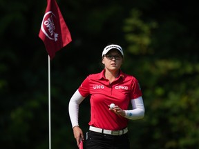 Brooke Henderson, of Canada, acknowledges applause from spectators after making par on the first hole during the final round at the LPGA CPKC Canadian Women's Open golf tournament in Vancouver on Sunday, Aug. 27, 2023.