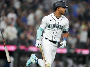 Seattle Mariners' Julio Rodriguez flips his bat after hitting a two-run home run to score J.P. Crawford against the Oakland Athletics during the fourth inning of a baseball game, Monday, Aug. 28, 2023, in Seattle.