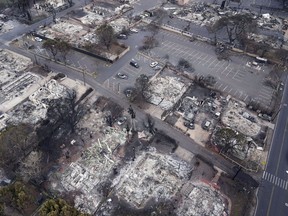 Wildfire wreckage is seen Thursday, Aug. 10, 2023, in Lahaina, Hawaii. Canadians returning from Maui have told of harrowing scenes before their escape from the fire-devastated Hawaiian island.