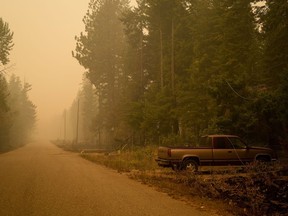 Downed power lines are seen on a pickup truck in an area burned by the Lower East Adams Lake wildfire, in Scotch Creek, B.C., on Sunday, August 20, 2023. Firefighters in British Columbia's southern Interior continue to battle a number of major blazes, having been aided by ample rainfall that fell yesterday over the Okanagan and Shuswap regions.THE CANADIAN PRESS/Darryl Dyck