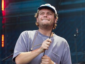 Mac DeMarco swings the microphone during his performance on Day 3 of the Osheaga Music and Arts Festival at Parc Jean-Drapeau in Montreal on Aug. 4, 2019.