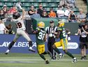B.C. Lions' receiver Justin McInnis makes a touchdown catch against the Edmonton Elks' Marloshawn Franklin Jr. (32) and Kai Gray (29) during first half of their July 29 meeting in Edmonton. 