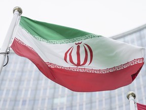 The flag of Iran waves in front of the the International Center building with the headquarters of the International Atomic Energy Agency, IAEA, in Vienna, Austria, Monday, May 24, 2021.