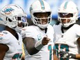 Tua Tagovailoa of the Miami Dolphins talks to teammates in the huddle in the second quarter of a game against the Los Angeles Chargers on Sunday.