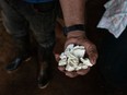 A worker holds coca paste in La Paz, Guaviare department, Colombia