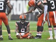 Cleveland Browns wide receiver Amari Cooper (2) is checked on by teammate running back Nick Chubb (24) during the first half of an NFL football game against the Cincinnati Bengals Sunday, Sept. 10, 2023, in Cleveland.