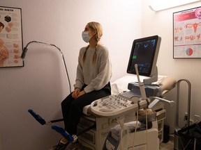 Megan sits in a monitoring room at her fertility clinic, waiting for a transvaginal ultrasound of her ovaries. During an egg-freezing cycle, women must attend monitoring appointments every few days.