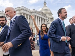 Lawmakers from the conservative House Freedom Caucus, the conservatives who are challenging Speaker McCarthy on the government funding bill, including Rep. Lauren Boebert, R-Colo., center, and Rep. Chip Roy, R-Texas, left, rally ahead of a news conference outside the Capitol in Washington, Tuesday, Sept. 12, 2023.