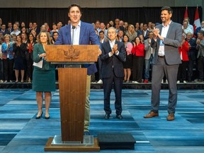 Primer Minister Justin Trudeau, flanked by Minister of Finance Christina Freeland and Sean Fraser, Minister of Housing, Infrastructure and Communities, backed by the Liberal caucus meeting in London, Ont., on Sept. 14.