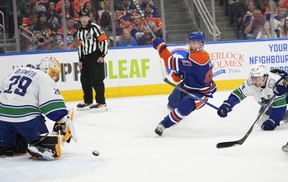 Edmonton Oilers Connor McDavid (97) shoots the puck past Vancouver Canucks goalie Casey DeSmith (29) during first period NHL pre-season action on Wednesday, Sept. 27, 2023 in Edmonton.