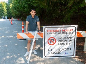 Lions Bay resident Ehsan Monfared at the closed parking lot for Brunswick Mountain, Tunnel Bluffs, the West Lion and Mount Harvey at the end of Sunset Drive in Lions Bay on Saturday. The village council closed the trailhead due to fire risk, but many are questioning that decision.