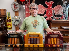 Wayne Learie of The Mad Pickers at his Aldergrove antique and auction house on Sept. 21 with various items from the estate of collector Bob Blais. Pictured are Addison radios.