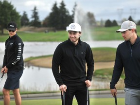 Vancouver Canucks' captain Quinn Hughes (centre) with Elias Pettersson (l) and Nils Hoglander (r) during the Jake Milford Canucks Charity Invitational Golf Tournament at the Northview Golf and Country Club in Surrey on Monday.
