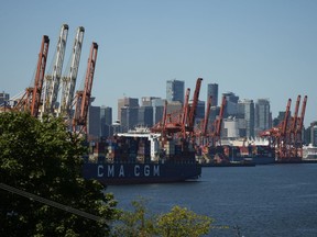A new report about ineffective and inadequate policing of Metro Vancouver port terminal facilities says there's "literally no downside" for organized criminals to set up shop, and one B.C. city is sounding the alarm. Gantry cranes sit idle as a container ship is docked at port during a work stoppage, in Vancouver, on Wednesday, July 19, 2023.