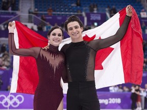 Decorated ice dance duo Tessa Virtue and Scott Moir are among the 2023 inductees into Canada's Sports Hall of Fame. The Ice dance gold medallists hold up the Canadian flag during victory ceremonies at the Pyeongchang Winter Olympics Tuesday, February 20, 2018 in Gangneung, South Korea.