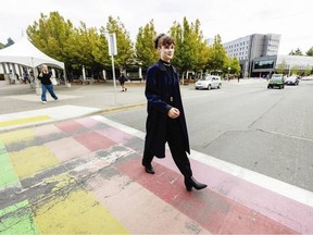 Cleo Philp, director of campaigns and community relations with the University of Victoria Students' Society, uses the Rainbow Crosswalk at UVic. It was first painted in 2015 and is fading. DARREN STONE, TIMES COLONIST
