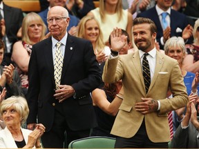 Sir Bobby Charlton and David Beckham in the royal box on centre court on day six of the Wimbledon Lawn Tennis Championships at the All England Lawn Tennis and Croquet Club at Wimbledon on June 28, 2014 in London, England.