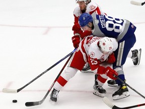 David Goyette, right, of the Sudbury Wolves, is knocked off the puck by Kirill Kudryavtsev and Ryan O'Rourke, of the Soo Greyhounds, during OHL action at the Sudbury Community Arena in Sudbury last season.