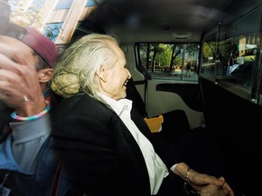 Seen through a police vehicle window, Canadian-Finnish fashion mogul Peter Nygard leaves a courthouse in Toronto on Sept. 26, 2023. Nygard, 82, is being tried on charges of sexual assault and forcible confinement dating to the 1980s.