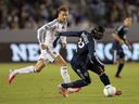 Darren Mattocks of the Vancouver Whitecaps is shadowed by David Beckham of the Los Angeles Galaxy during their 2012 playoff match at The Home Depot Center in Carson, Calif.