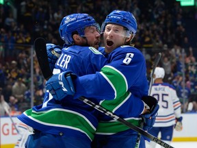 Brock Boeser is congratulated by J.T. Miller after scoring the first of three goals against the Edmonton Oilers at Rogers Arena on Wednesday night