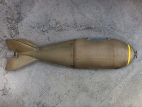 Ancient military missile bomb in front of an eroded grey background.