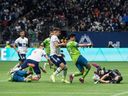 Vancouver Whitecaps goalkeeper Maxime Crepeau, right, smothers the ball just in front of Seattle Sounders forward Fredy Montero in extra time of their Decision Day game in 2021. If Crepeau hadn't made the save to preserve the tie, the Caps wouldn't have made the playoffs that year.