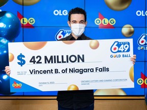 Vincent Biamonte holds his $42-million cheque after winning on the June 14, 2023 Lotto 6/49 gold ball ticket.