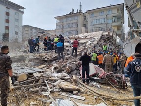 Rescuers carry on search operations among the rubble of collapsed buildings in the Yesilyurt district of Malatya on Feb. 27 after a 5.6 magnitude earthquake hit eastern Turkey, killing one person and wounding dozens of others, the government's disaster agency said.