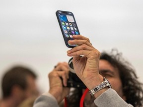A person photographs the Apple iPhone 15 Pro during a launch event at Apple Park in Cupertino, California, on September 12, 2023.