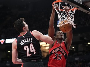 Toronto Raptors centre Christian Koloko (35) dunks the ball past Portland Trail Blazers forward Drew Eubanks (24) during second half NBA basketball action in Toronto on Sunday, Jan. 8, 2023. The Raptors centre is out indefinitely the team announced Monday just before their season-opening media day.
