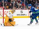 Vancouver Canucks' Elias Pettersson (right) scores on Nashville Predators goalie Juuse Saros during the shootout on Monday, March 6, 2023. The Canucks defeated the Predators 4-3.