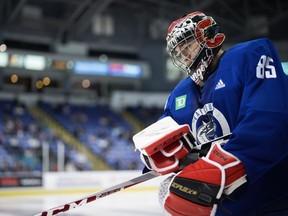 Vancouver Canucks goalie Ty Young skates back to the net after taking a break during the opening day of the NHL hockey team's training camp, in Victoria, Thursday, Sept. 21, 2023.