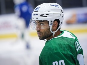 Vancouver Canucks' Arshdeep Bains waits for an on-ice session to begin during the opening day of the NHL hockey team's training camp, in Victoria, Thursday, Sept. 21, 2023.