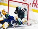 Seattle Kraken's Andrew Poturalski (12) scores on Vancouver Canucks goaltender Casey DeSmith (29) during the first period of an NHL preseason game in Abbotsford, B.C. on Wednesday, Oct. 4, 2023.
