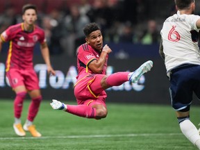 St. Louis City's Nicholas Gioacchini, centre, watches the ball after using his head to direct it on goal against the Vancouver Whitecaps during the first half of an MLS soccer match in Vancouver, on Wednesday, October 4, 2023.