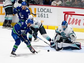 Vancouver Canucks' Pius Suter (24) takes a shot on Seattle Kraken goaltender Joey Daccord (35) during the second period of preseason NHL action in Abbotsford, B.C. on Wednesday, Oct. 4, 2023.