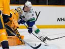 Nashville Predators goaltender Juuse Saros, left stops a shot on goal by Vancouver Canucks left wing Anthony Beauvillier (72) during the first period on Tuesday in Nashville, Tenn.