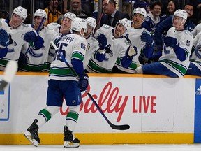 Vancouver Canucks right wing Ilya Mikheyev (65) is congratulated by teammates after a goal against the Nashville Predators during the first period on Tuesday, Oct. 24, 2023, in Nashville, Tenn.