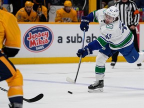 Vancouver Canucks defenceman Quinn Hughes (43) shoots the puck against the Nashville Predators during the first period on Tuesday in Nashville, Tenn.
