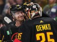 Vancouver Canucks' Elias Pettersson, back left, and goalie Thatcher Demko celebrate after Vancouver defeated the Nashville Predators 5-2 at Rogers Arena on Tuesday night.